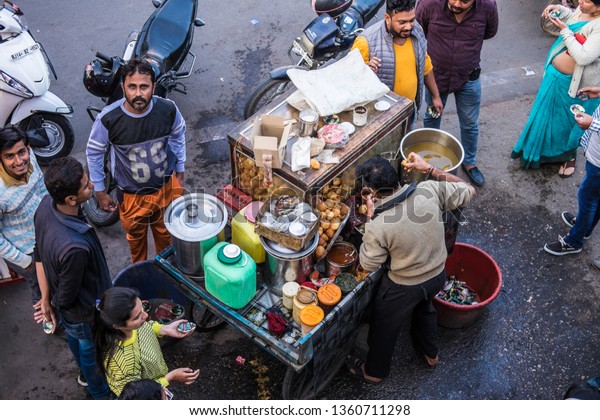 Johdpur, India - December 24, 2018, Locals buying\
panipuri from a trishaw street panipuri\'s vendor at roadside, a\
common street snack in\
India.