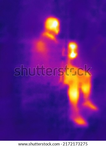 John. Athlete during exercise, body-building. Human heat map. Blurred unrecognizable people.