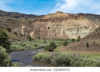 The John Day river flows by Cathedral Rock at the John Day Fossil Beds National Monument in Oregon, USA