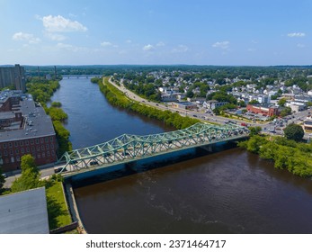 John E. Cox Memorial Bridge aerial view over Merrimack River at Lowell National Historical Park in historic downtown Lowell, Massachusetts MA, USA. 