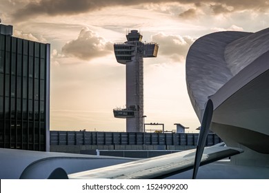 The John F. Kennedy Airport (JFK) Air Traffic Control Tower During The Evening Light With The Historic TWA Terminal And The Old Lockheed Starliner Wing. Queens New York USA, October 2, 2019