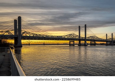 John F. Kennedy Bridge and Abraham Lincoln Bridge crossing the Ohio River between Louisville, Kentucky and Jeffersonville, Indiana at sunset.
