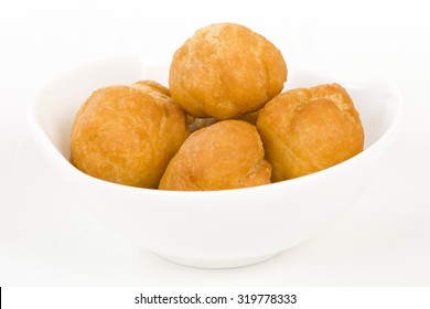Johnny Cakes - Jamaican fried dumplings in a white bowl.