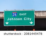 Johnson City, USA road street interstate highway green sign for i26 26 east to Johnson City in Tennessee with text isolated closeup and blue sky