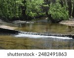 Johnson Creek runs over a small concrete low-water bridge at the entrance of Paris Springs Access, located off of Old Route 66 in Lawrence County, MO, Missouri, US, USA, United States.  