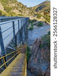 Johnsondale Bridge over Kern River with yellow stairs leading to the river trail in Camp Nelson, California