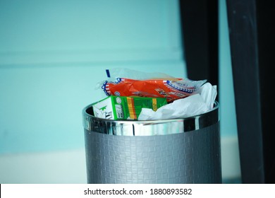 Johor Bahru, Malaysia- 6 December 2020. The Photograph Of Full Bin With Rubbish In The Light Blue Room Colour. Photograph Contain Minimal Grain And Noise.