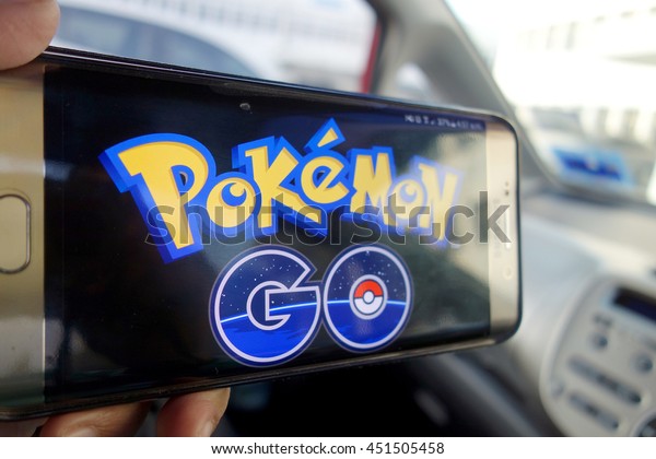 JOHOR, MALAYSIA -\
JULY 13TH, 2016 : An Android user plays Pokemon Go in a car, a\
free-to-play augmented reality mobile game developed by Niantic for\
iOS and Android devices.