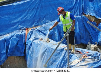 JOHOR, MALAYSIA -JUNE 26, 2015: Construction Workers Spraying The Anti Termite Chemical Treatment To The Soil At The Construction Site. 
