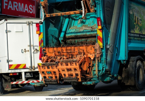 JOHOR, MALAYSIA -\
MAY 5, 2018: Worker of urban municipal recycling garbage collector\
truck loading waste and trash bin in Johor Bahru Street, Johor,\
Malaysia. Taken on May 5,\
2018.