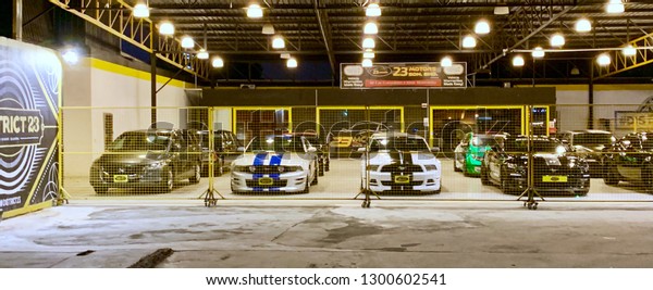 Johore , Malaysia- January 32, 2019 :
Unidentified car care staff cleaning the car (Car detailing). Image
contain certain grain or noise and soft
focus.