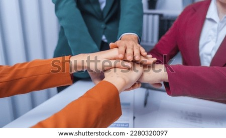 join hands teamwork concept. small business accounting team meeting three asian people with salary monthly charts data, basic business accounting and bookkeeping concept.
