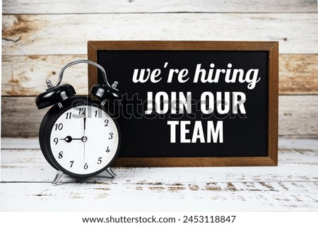 Join our team text message written on chalkboard with alarm clock