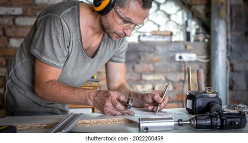 Joiner in the process of work, measurements, drilling accuracy. - Shutterstock ID 2022200459