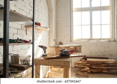 Joinery shop interior with tools and supplies, woodwork machines and equipment, instruments on workbench, starting small carpentry workshop business concept, making wooden ware, custom made furniture - Shutterstock ID 637341667