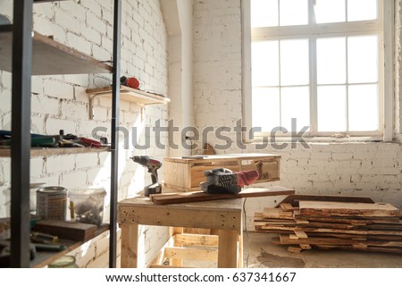 Joinery shop interior with tools and supplies, woodwork machines and equipment, instruments on workbench, starting small carpentry workshop business concept, making wooden ware, custom made furniture