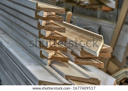 Joinery. Stacked door architraves. Wood door manufacturing process. Woodworking and carpentry production. Furniture manufacture. Close-up