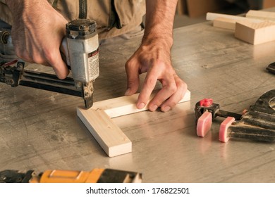 joinery uses a nail gun to attach pieces of wood