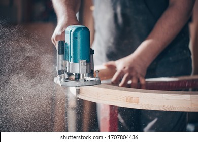 Joinery, woodworking and furniture making, professional carpenter cutting wood in carpentry shop, industrial concept - Shutterstock ID 1707804436