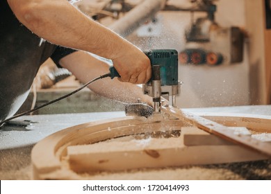 Joinery, woodworking and furniture making, professional carpenter cutting wood in carpentry shop, industrial concept