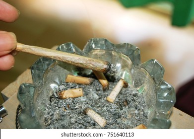 Joint Being Ashed Into A Dirty Ash Tray