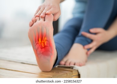 Joint diseases, hallux valgus, plantar fasciitis, heel spur, woman's leg hurts, pain in the foot, massage of female feet at home, health problems concept, BeH3althy - Shutterstock ID 2258156327