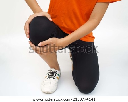 Joint knee pain, arthritis and tendon problems. a woman touching knee at pain point on white background.
