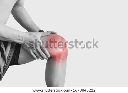 Joint pain, Arthritis and tendon problems. a man touching nee at pain point, on white background