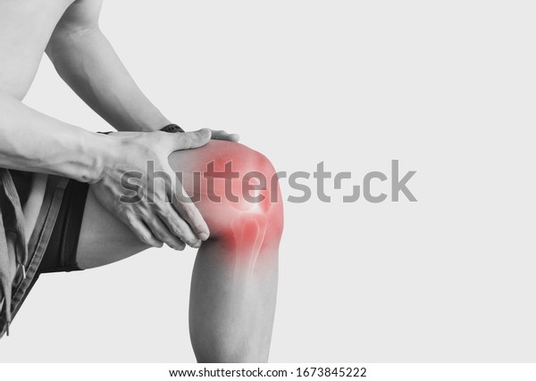 Joint pain, Arthritis and\
tendon problems. a man touching nee at pain point, on white\
background