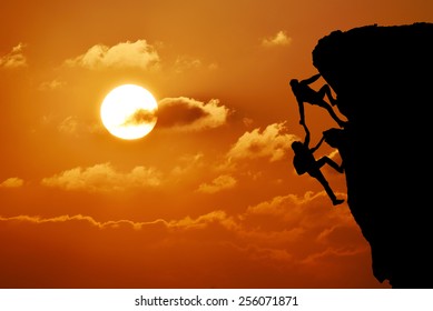 The Joint Work Teamwork Of Two Men Travelers Help Each Other On Top Of A Mountain Climbing Team, A Beautiful Sunset Landscape