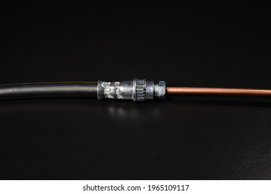Jointing of Brake Hose and copper brake pipe on black background.
