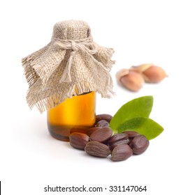 Jojoba (Simmondsia chinensis) leaves, seeds with oil. Isolated on withe beckground.
