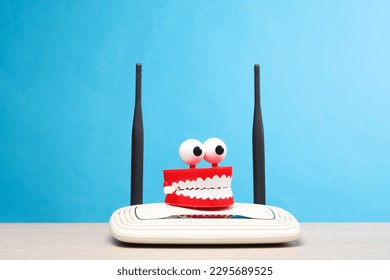 Joke jaw with wi-fi router on the table, blue background
