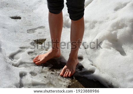 A joke where a friend throws a girl out of the house and lets her stand in the snow without shoes and locks her down. walking on snow bare feet on a sunny January day