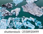 Jokulsarlon glacial lagoon, Iceland at sunset. Beautiful blocks of ice and some seals flow through the cold water coming off the mountain. Landscape of the largest glacier in Iceland and Europe