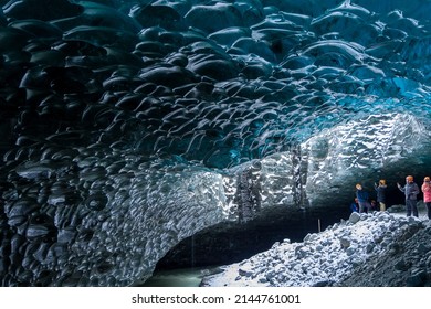 JOKULSARLON,ICELAND - NOVEMBER 18 2021: Tourists exploring the inside of a spectacular ice cave under the Vatnajökull glacier in southern Iceland