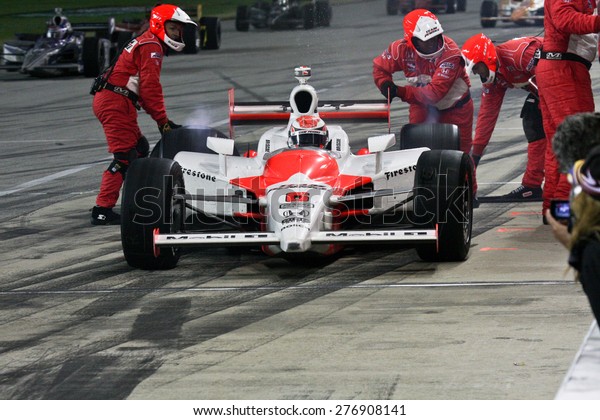 Joliet Illinois, USA - August 29, 2009: IndyCar
Racing League. Pit stop during the race. Ryan Brisco driver for
Penske racing. Team changes tires and fuels the car. Chicagoland
speedway. Night Racing