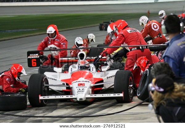 Joliet Illinois, USA - August 29, 2009: IndyCar\
Racing League. Pit stop. Ryan Brisco driver, Penske racing team.\
Team changes tires and fuels the car. Chicagoland speedway. Night\
Racing under lights.