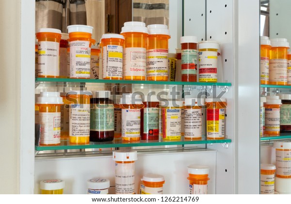 Joliet, Illinois / USA - October 29, 2017:\
A medicine cabinet full of prescription drug bottles. Medicines\
include prescription opioid pain\
killers.