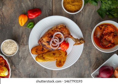 Jollof Rice And Chicken Dish With Peppers And Salad. African - Nigerian Jollofrice And Chicken Dish With Peppers And Salad. Nigeria Cuisine. Tasty Chicken African Cuisine. Grilled Chicken Food