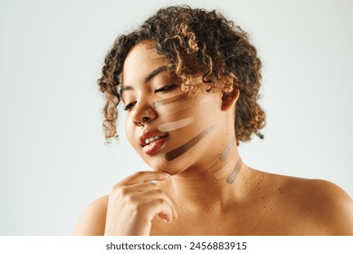 Jolly African American woman with foundation on face poses against vibrant backdrop. - Powered by Shutterstock