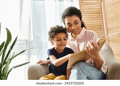 jolly attractive african american woman in homewear reading book to her adorable son at home - Powered by Shutterstock