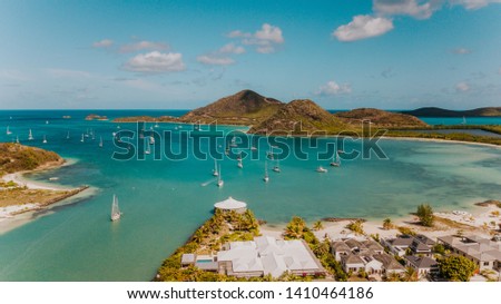 Jolly Harbour view in Antigua with tropical nature, sailboats anchoring in a bay, Caribbean sea, in the blue water, lagoon, sailing in the Caribbean islands