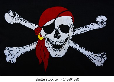 Jolly Roger on black textiles background - Shutterstock ID 145694360