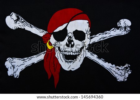 Jolly Roger on black textiles background