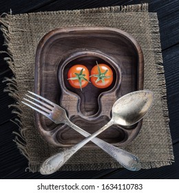 Jolly Roger Skulls And Crossbones Theme Made With Tomatoes, Onion, Spoon And Fork On Wooden Background