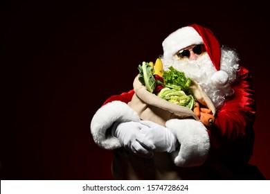 Jolly Santa Claus Is Holding A Big Sack Full Of Fruits And Vegetables. Enjoy A Healthy Christmas Dinner. Healthy Christmas Recipes. Christmas Diet.