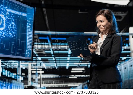 Jolly server room software developer using AI feeling happy by upgraded cloud storage gear increased performance. Smiling data center admin pleased by artificial intelligence processing large datasets