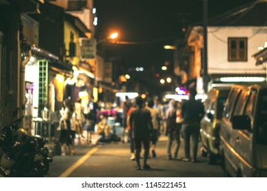 Jonker Street at night People visiting the night market at Jonker Walk street Malacca, Malaysia at night blurred background. listed as a UNESCO World Heritage