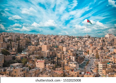 Jordan Flag In Amman, Landscape View Of Cloudy Sky Background 